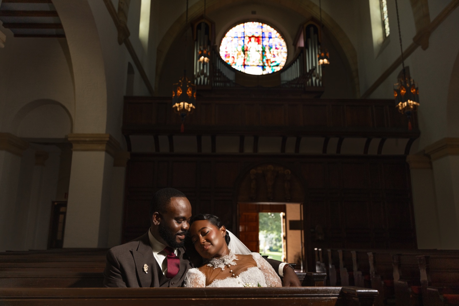 Bride and groom sharing a quiet moment at a historic church altar