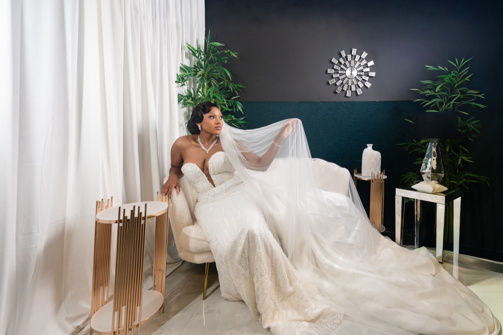 Editorial bridal portrait on a chaise lounge in a moody suite