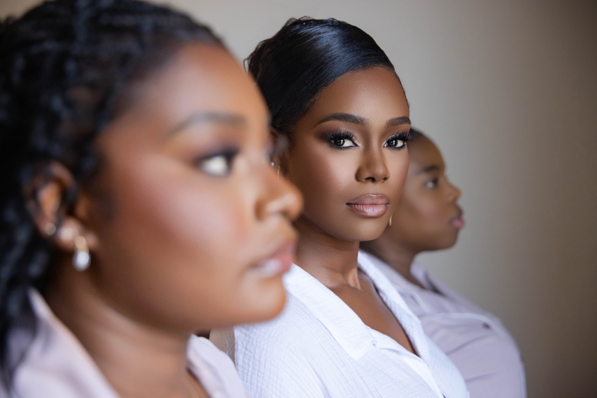 Bride and bridesmaids in soft light on the wedding morning